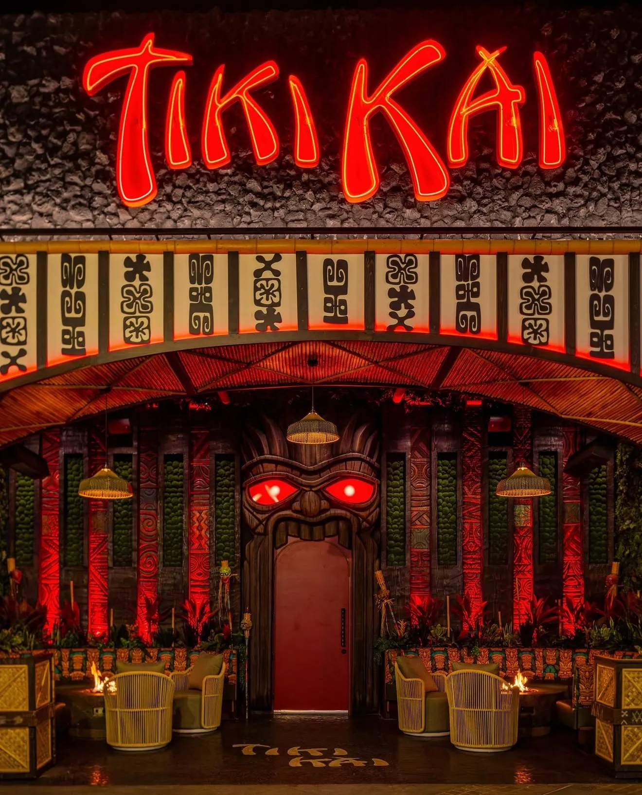 Illuminated Tiki Kai restaurant sign at night