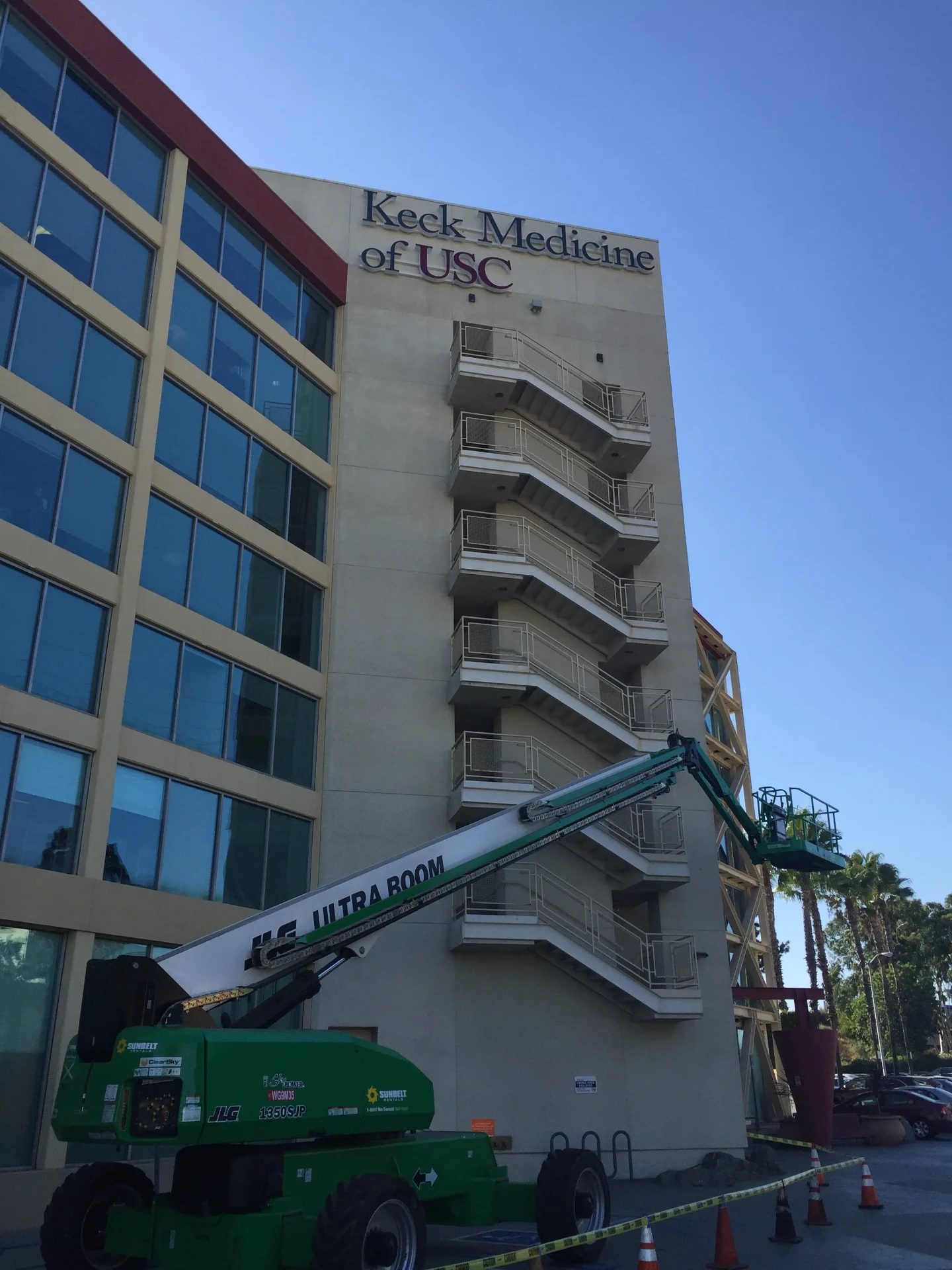 High-rise sign installation with suspended crew